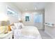 Light and airy bedroom with a queen bed and an ensuite bathroom at 803 E 11Th Ave, New Smyrna Beach, FL 32169