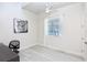 Bright home office features ceiling fan, wood-look floors, and large window at 803 E 11Th Ave, New Smyrna Beach, FL 32169