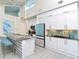 Contemporary kitchen with white cabinets and a large granite island at 803 E 11Th Ave, New Smyrna Beach, FL 32169