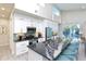 Modern kitchen boasts white cabinets, a large island, and blue refrigerator at 803 E 11Th Ave, New Smyrna Beach, FL 32169