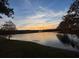 Scenic lake view at sunset with a fountain at 8610 Tallfield Ave, Orlando, FL 32832