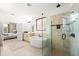 Spa-like bathroom with soaking tub, walk-in shower and view to bedroom at 9111 Outlook Rock Trl, Windermere, FL 34786