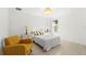 Bright bedroom with a comfortable bed and a mustard yellow accent chair at 9111 Outlook Rock Trl, Windermere, FL 34786