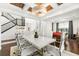 Modern dining room with white table, chandelier, and access to game room at 9111 Outlook Rock Trl, Windermere, FL 34786