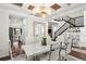 Modern dining room with white table and chairs, hardwood floors, and an open floor plan at 9111 Outlook Rock Trl, Windermere, FL 34786