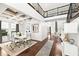 Bright dining room with white table and chairs, hardwood floors, and a high ceiling at 9111 Outlook Rock Trl, Windermere, FL 34786