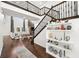 Elegant entryway with hardwood floors, a staircase with wrought iron railing, and built-in shelving at 9111 Outlook Rock Trl, Windermere, FL 34786