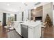 Open concept kitchen with white cabinets and an island, overlooking living area at 9111 Outlook Rock Trl, Windermere, FL 34786
