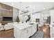 Open concept kitchen features white cabinetry, large island, and hardwood floors at 9111 Outlook Rock Trl, Windermere, FL 34786