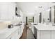 Bright kitchen with white cabinets, stainless steel appliances and an island at 9111 Outlook Rock Trl, Windermere, FL 34786