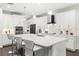 Modern kitchen with white cabinets, quartz countertops, and a large island at 9111 Outlook Rock Trl, Windermere, FL 34786