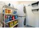 Laundry room with washer, dryer, and shelving for storage at 9111 Outlook Rock Trl, Windermere, FL 34786