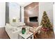 Modern living room with large sectional sofa, hardwood floors and a Christmas tree at 9111 Outlook Rock Trl, Windermere, FL 34786