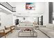 Open living room with high ceilings, modern furniture, and a view of the kitchen at 9111 Outlook Rock Trl, Windermere, FL 34786