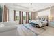 Spacious main bedroom with plush bed and sitting area at 9111 Outlook Rock Trl, Windermere, FL 34786