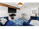 Media room with blue velvet couches and a large TV at 9111 Outlook Rock Trl, Windermere, FL 34786