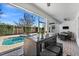 Relaxing pool area with patio furniture and screened-in lanai at 9111 Outlook Rock Trl, Windermere, FL 34786