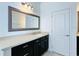 Bathroom with dark brown vanity and a large mirror at 12276 Alder Branch Loop, Orlando, FL 32824