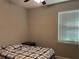 Bright bedroom with a twin-sized bed, window with blinds, and neutral-colored walls at 1493 Park Dr, Casselberry, FL 32707