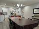 Open concept dining room with a large table and modern kitchen at 1493 Park Dr, Casselberry, FL 32707