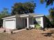 Newly built home with a white exterior, red door, and a two-car garage at 1493 Park Dr, Casselberry, FL 32707