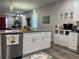 Modern kitchen featuring granite countertops, white cabinetry, and stainless steel appliances at 1493 Park Dr, Casselberry, FL 32707