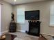 Living room with a fireplace, large TV, and hardwood floors at 1493 Park Dr, Casselberry, FL 32707