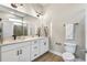 Modern bathroom with double vanity, large mirror, and a walk-in shower at 1800 Houston St, Kissimmee, FL 34743