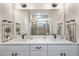 Elegant bathroom featuring a double vanity, quartz countertop, and a large mirror at 1800 Houston St, Kissimmee, FL 34743