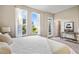 Bright bedroom with large windows offering scenic views and a private balcony at 1800 Houston St, Kissimmee, FL 34743