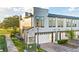 Contemporary townhome with gray exterior, white garage door, and brick accents at 1800 Houston St, Kissimmee, FL 34743