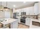 Modern kitchen with white cabinets and a large island at 1800 Houston St, Kissimmee, FL 34743