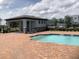Community pool with brick deck and covered seating area at 1800 Houston St, Kissimmee, FL 34743