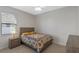 Cozy bedroom with a queen-size bed and wood nightstand at 1869 Brockridge Rd, Kissimmee, FL 34744