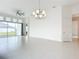 Dining room with elegant chandelier, tile floors, and large windows overlooking the backyard at 234 Mosaic Blvd, Daytona Beach, FL 32124