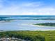 Stunning aerial view showcasing a vast landscape, serene waters, and distant horizon at 2545 Harris Blvd, Kissimmee, FL 34746