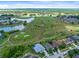 Aerial view of community, showcasing homes, golf course and water at 2545 Harris Blvd, Kissimmee, FL 34746