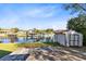 White shed in backyard near canal, offering extra storage at 2545 Harris Blvd, Kissimmee, FL 34746