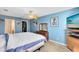 Spacious bedroom with ceiling fan, TV, and ample closet space at 2545 Harris Blvd, Kissimmee, FL 34746