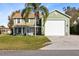 Two-story house with a large garage and landscaped lawn at 2545 Harris Blvd, Kissimmee, FL 34746