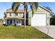 Two-story house with green exterior, large garage, and palm tree at 2545 Harris Blvd, Kissimmee, FL 34746