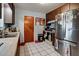 Kitchen featuring wooden cabinets, stainless steel refrigerator, and tile floor at 262 Valencia Rd, Debary, FL 32713