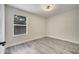 Unfurnished bedroom with gray wood-look floors, a ceiling fan, and a window at 313 Bent Way Ln, Lake Mary, FL 32746