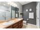 Modern bathroom featuring double sinks, a large mirror, and a walk-in shower at 3907 Baja Dr, St Cloud, FL 34772