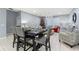 Dining table with gray upholstered chairs and a festive centerpiece, adjacent to the living area at 3907 Baja Dr, St Cloud, FL 34772
