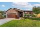 Well-maintained house featuring a brown garage door and manicured lawn at 3907 Baja Dr, St Cloud, FL 34772