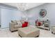 Comfortable living room featuring a sofa, ottoman, and large mirror at 3907 Baja Dr, St Cloud, FL 34772