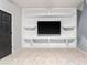 Built-in shelving and a large screen TV in media room at 3907 Baja Dr, St Cloud, FL 34772