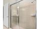 Modern bathroom with a glass-enclosed shower and tiled walls at 4141 Lana Ave, Davenport, FL 33897