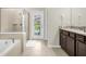 Spacious bathroom with soaking tub, separate shower, and direct pool access at 4141 Lana Ave, Davenport, FL 33897
